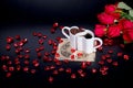 Red roses and red glass hearts next to heart shaped coffee mugs Royalty Free Stock Photo