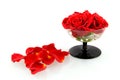 Red roses in glass with rose leaves Royalty Free Stock Photo