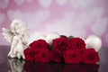 Red roses and gray wicker hearts and angel for valentine`s day