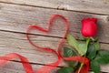 Red roses and heart shape ribbon over wood Royalty Free Stock Photo