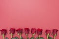 Red roses over red background flat lay. Valentine's Day, Birthday abstract background with copy space