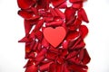 Red roses petals and heart Royalty Free Stock Photo