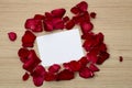 red roses petals and white blank paper Royalty Free Stock Photo