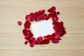 red roses petals and white blank paper Royalty Free Stock Photo