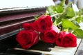 Red roses on piano vintage romantic valentines Royalty Free Stock Photo