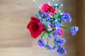 Purple flowers bouquet in a clear glass jar. Overhead shot.