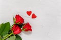 Red roses and two wooden hearts on textured concrete background from above. Love and togetherness concept. Valentines day, mothers Royalty Free Stock Photo