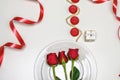 Red Roses on a white plate, candles and giftbox. Romantic composition for Valentine`s Day, Anniversary, Events. Place Royalty Free Stock Photo