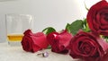 Red roses on white table near silver ring with big violet crystal Royalty Free Stock Photo