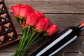 Red roses, wine bottle and chocolate box Royalty Free Stock Photo