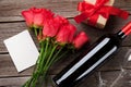 Red roses, wine bottle and Valentine`s day gift