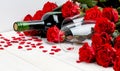 Red roses and wine on white background