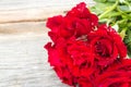 Red roses on wood background.