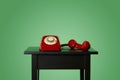 Red rotary dial telephone off the hook on a table Royalty Free Stock Photo