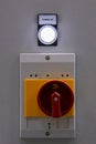 Red rotary power button and warning light close - up at the factory. Royalty Free Stock Photo