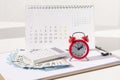 Red round alarm clock , calculator, calendar and euro banknoteseuro banknotes. planning concept, business concept