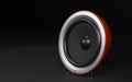 Red round audio speaker over black background