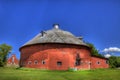 Red Round Barn with Church Royalty Free Stock Photo