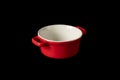 Red round ceramic mold baking dish. Isolated on black background Royalty Free Stock Photo
