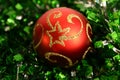 Red round fur-tree sphere on a tinsel