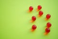 Red round vitamins on a green table. Copy space Royalty Free Stock Photo