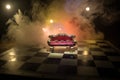 Red royal chair miniature on wooden table. Medieval Throne on chessboard. Chess board game concept of business ideas and