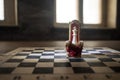 Red royal chair miniature on wooden table. Medieval Throne on chessboard. Chess board game concept of business ideas and