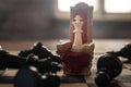 Red royal chair miniature on wooden table. Medieval Throne on chessboard. Chess board game concept of business ideas and