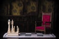 red royal chair miniature wooden table medieval throne chessboard chess board game concept business ideas competition strategy Royalty Free Stock Photo