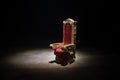 Red royal chair miniature on wooden table. Place for the king. Medieval Throne