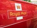 A red Royal Mail deliver van, logo sign. London, UK.