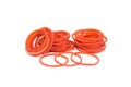 Red rubber band.Pile of rubber bands with rubberband standing out alone over white background. Royalty Free Stock Photo