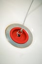Red rubber bath plug on chain Royalty Free Stock Photo