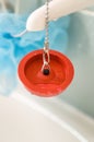 Red rubber bath plug on chain Royalty Free Stock Photo