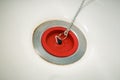 Red rubber bath plug on chain Royalty Free Stock Photo