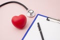 Red Rubber Heart, Stethoscope, and Clipboard with Pen Royalty Free Stock Photo