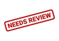 Red rubber stamp imprinted with the words Needs Review for important documentation Royalty Free Stock Photo