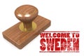Red rubber stamp with welcome to Sweden
