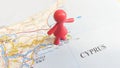 A red rubber toy woman overlooking Ayia Napa on a map of Cyprus