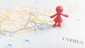 A red rubber toy woman protecting Ayia Napa standing on a map of Cyprus Royalty Free Stock Photo