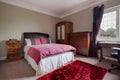 Red rug furnished bedroom Royalty Free Stock Photo