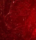red rumpled foil or polyethylene on a red background. Hard light, facets of folds. Abstract background for design Royalty Free Stock Photo