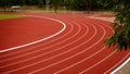 Red running track in public stadium. Sport Backgrounds