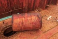 Red rusted metal barrel with traces of oil on board dry cargo ship. Abandoned shipwrecked vessel. View from the deck.