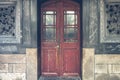 Red rustic door on black antique wall