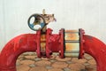 Red rusty metal industrial water pipes with a valve. Royalty Free Stock Photo