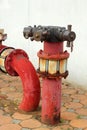 Red rusty metal industrial water pipes with a valve. Royalty Free Stock Photo