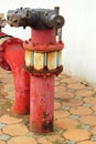 Red rusty metal industrial water pipes with a valve. Royalty Free Stock Photo