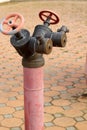 Red rusty metal industrial water pipes with a valve. Royalty Free Stock Photo