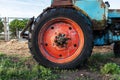 Red rusty wheel from a tractor close up